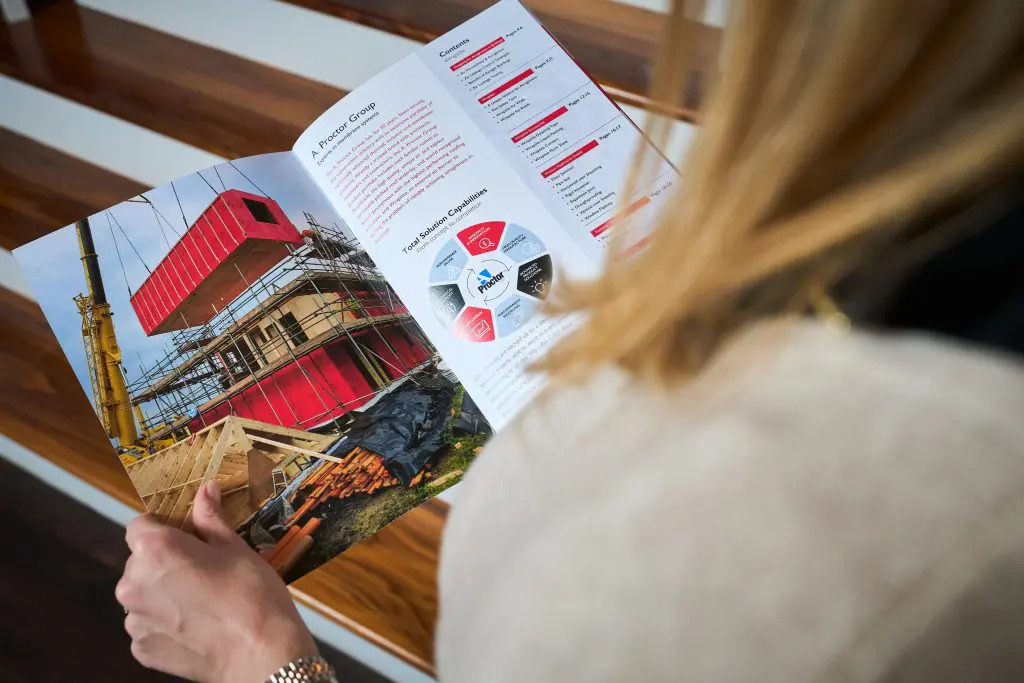 Blonde woman reading a magazine.